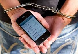 Person's hands handcuffed with cell phone 