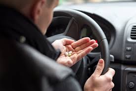 Pills in the palm of driver's hand
