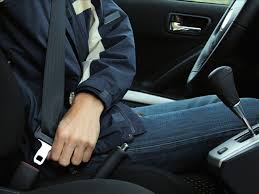 Close up of person buckling seat belt